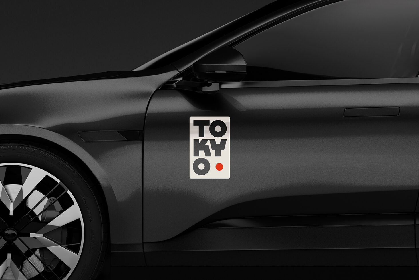 Black car with modern Tokyo sticker on door; sleek design; automotive mockup asset for designers; dark background; stylish vehicle branding.
