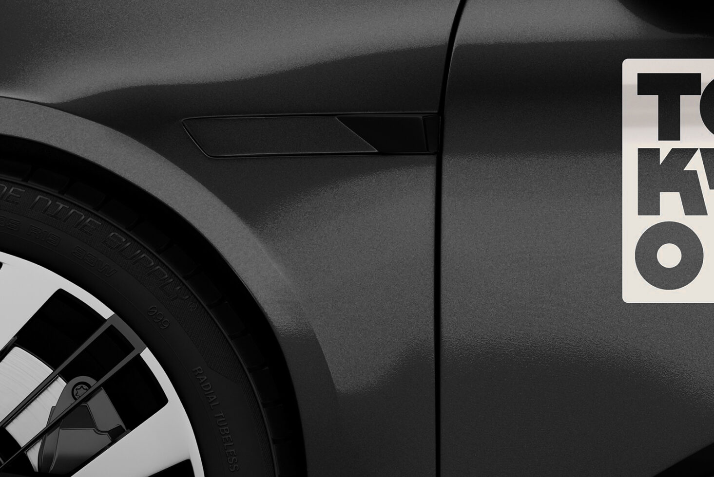 Close-up of a sleek car wheel and body with a modern Tok sticker. Ideal for automotive mockup designs and creative branding assets.