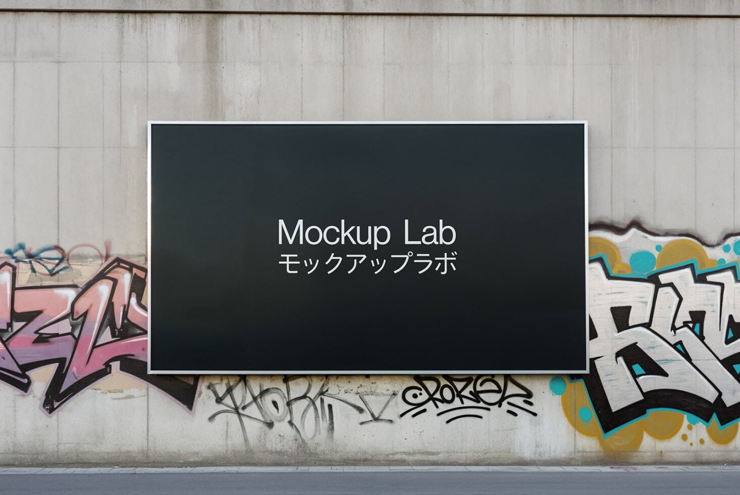 Dark horizontal billboard frame on concrete wall surrounded by colorful graffiti