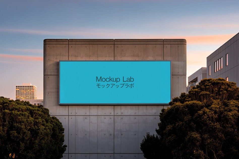 Bright cyan billboard mounted on concrete building with surrounding greenery