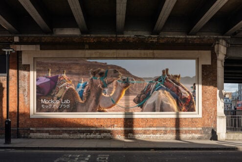 Urban poster mockup featuring camels in a desert landscape, ideal for showcasing advertising designs, street art, and graphic design projects.