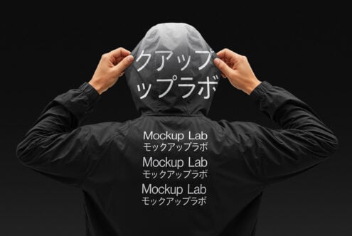 A person wears a black jacket featuring Mockup Lab text, ideal for clothing mockups. Hooded design shows branding options in English and Japanese.