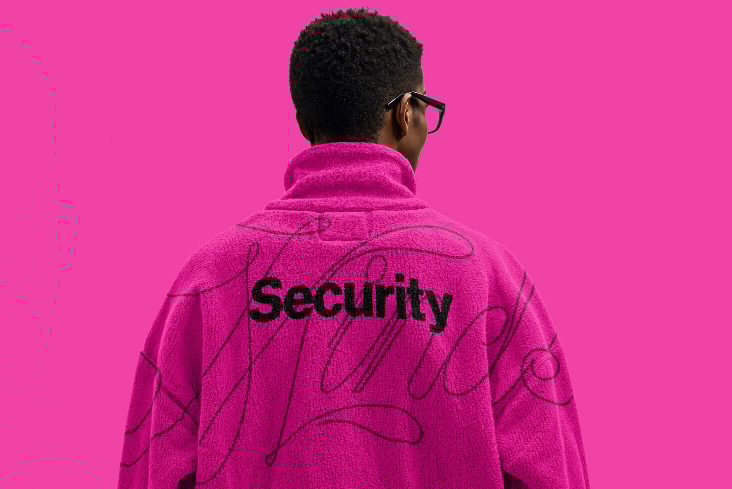 Person wearing pink jacket with security text on back standing against bright pink background ideal for graphic design templates mockups apparel projects