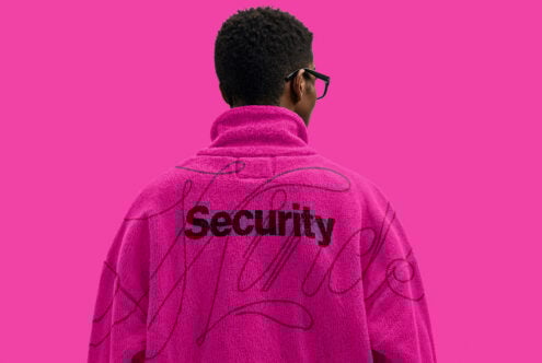 Person wearing pink jacket with security text on back standing against bright pink background ideal for graphic design templates mockups apparel projects