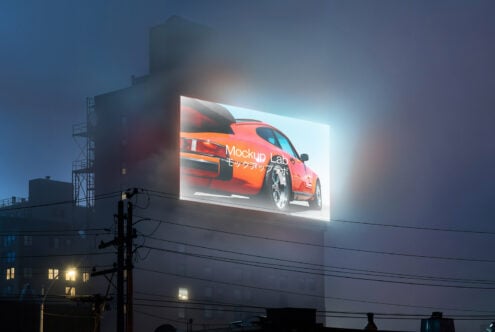 Illuminated urban billboard mockup featuring a sleek car design against a foggy night cityscape perfect for designers seeking realistic advertisement visuals