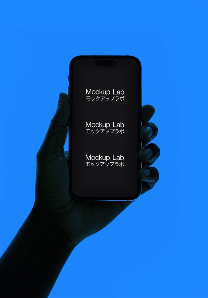 Hand holding a smartphone displaying Mockup Lab text in English and Japanese on a blue background. Ideal for designers seeking digital mockups.