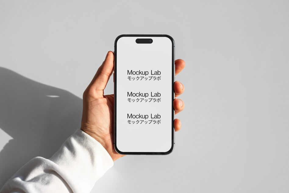 Hand holding iPhone with white screen showing repeated Mockup Lab text