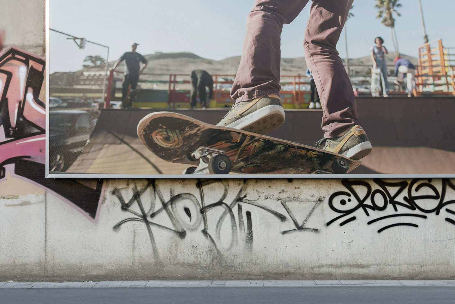 Skateboard photo print mounted on concrete wall with street art graffiti
