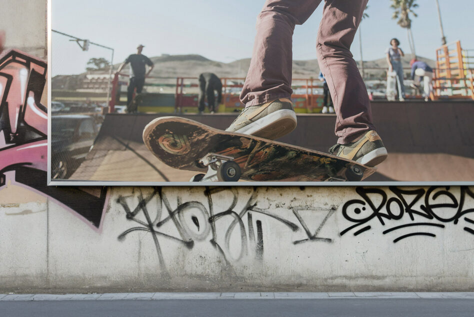 Skateboarder mid-trick at skatepark ramp with graffiti wall background urban street art sports theme perfect for digital design mockups and graphics.