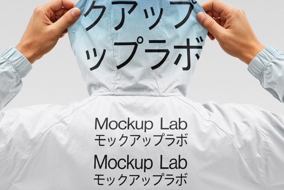 Light blue windbreaker being held up with Japanese characters print