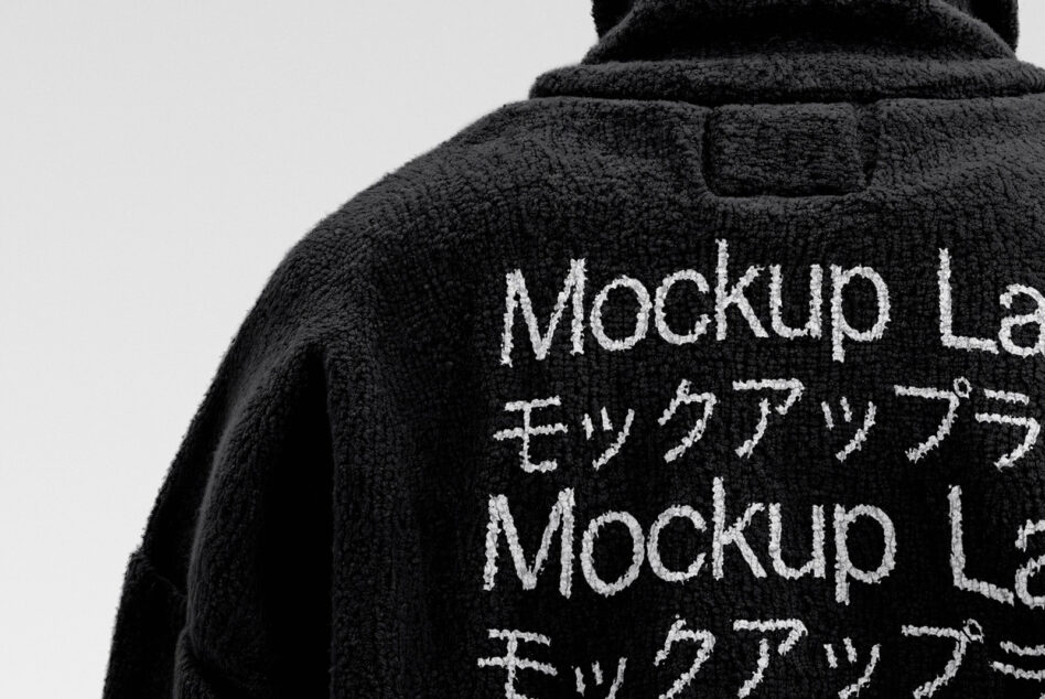 Black fleece jacket back view showing white embroidered text mockup
