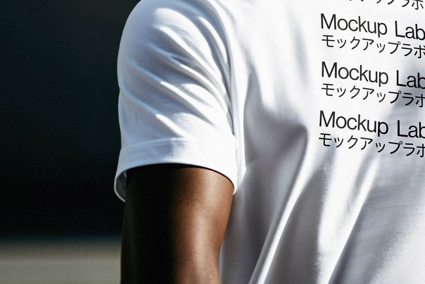 Close-up of a white t-shirt featuring text in English and Japanese. Ideal for apparel mockups showcasing font design and layout for designers.