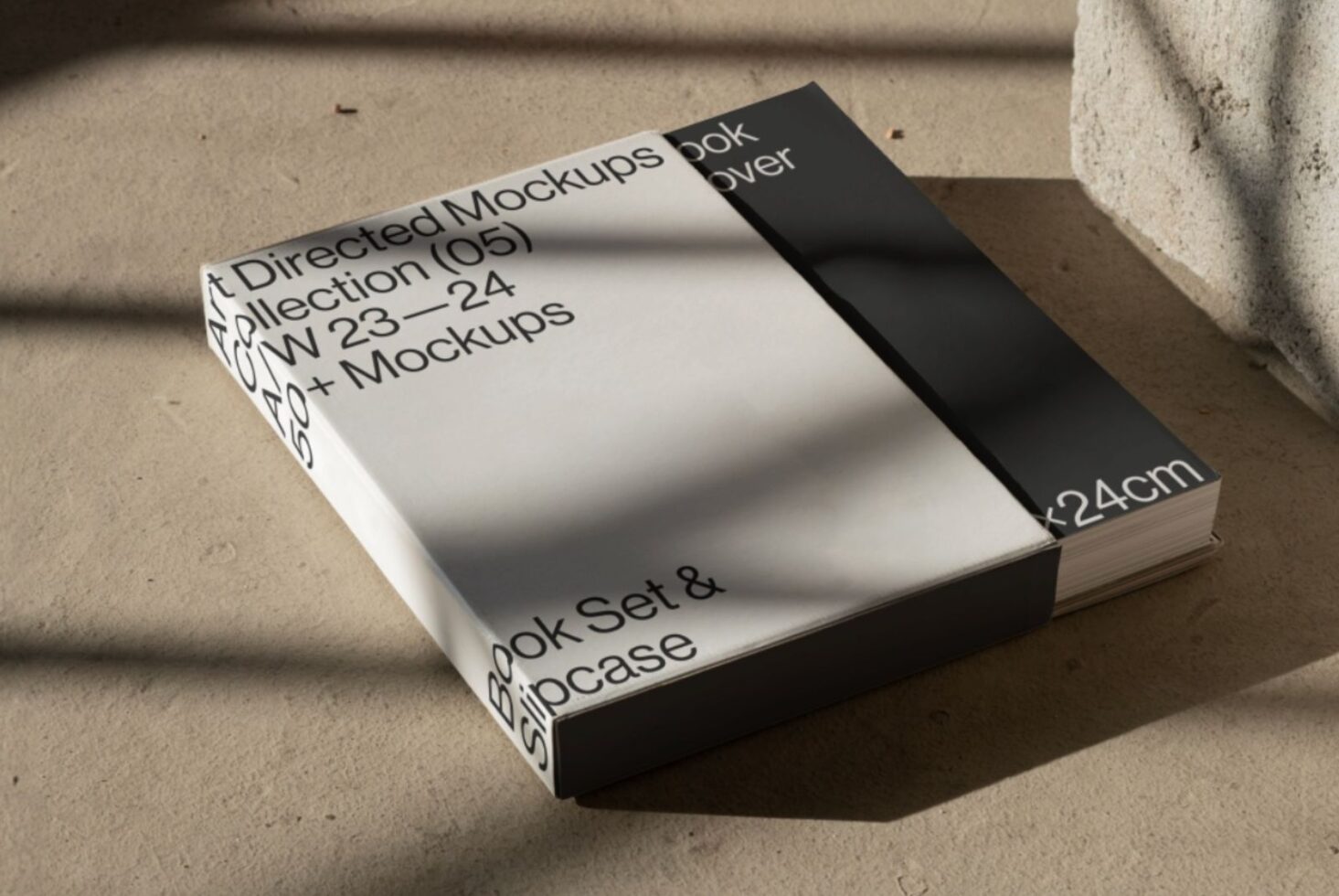 Art directed mockups book set with slipcase on concrete surface, showcasing modern design templates for creative professionals and digital asset designers.