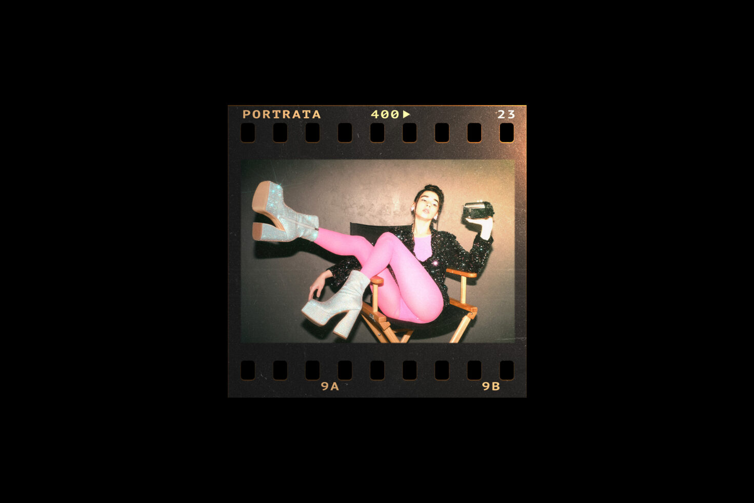 Film frame with a stylish person in pink tights and glitter boots sitting on a chair holding a vintage camera. Retro aesthetic for graphic design.