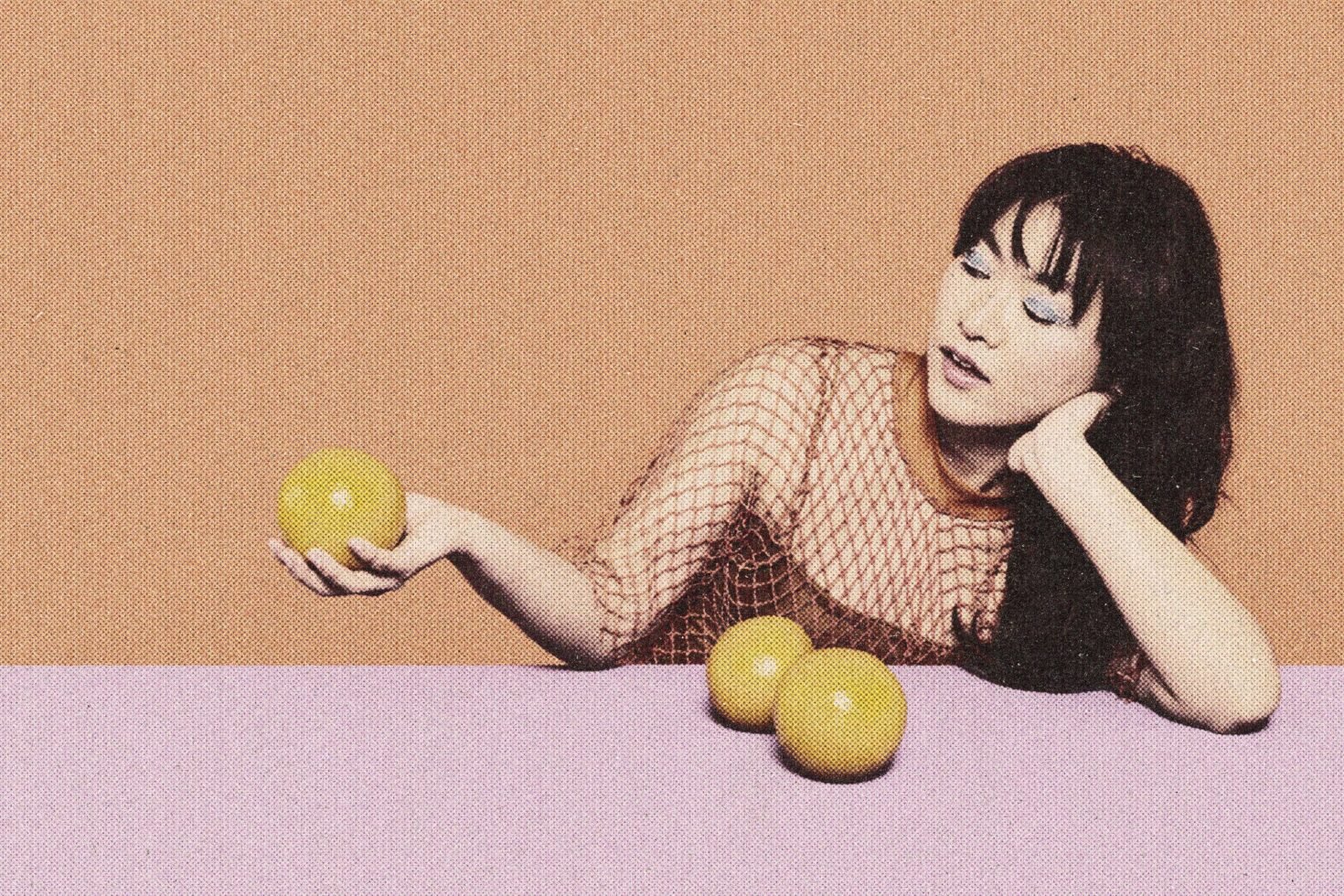 Pop art style image of woman in mesh top with lemon-colored balls on a pink and orange background. Ideal for graphic designers seeking vibrant art assets.