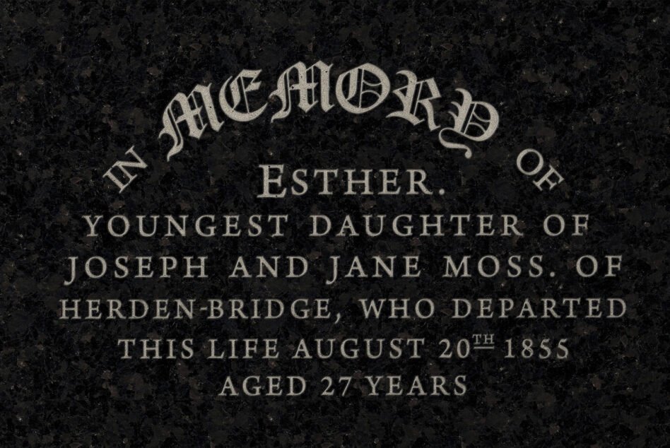 Victorian gravestone engraving with ornate serif lettering on black marble texture