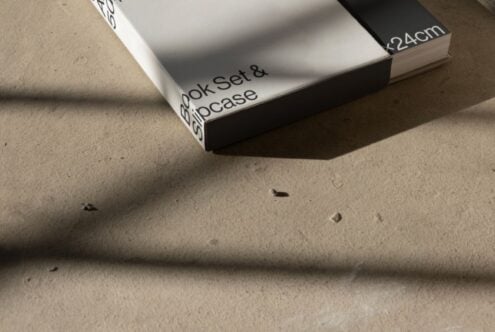 Minimalist book set with slipcase on concrete floor surface ideal for mockup use design templates modern aesthetics shadows keyword asset designers