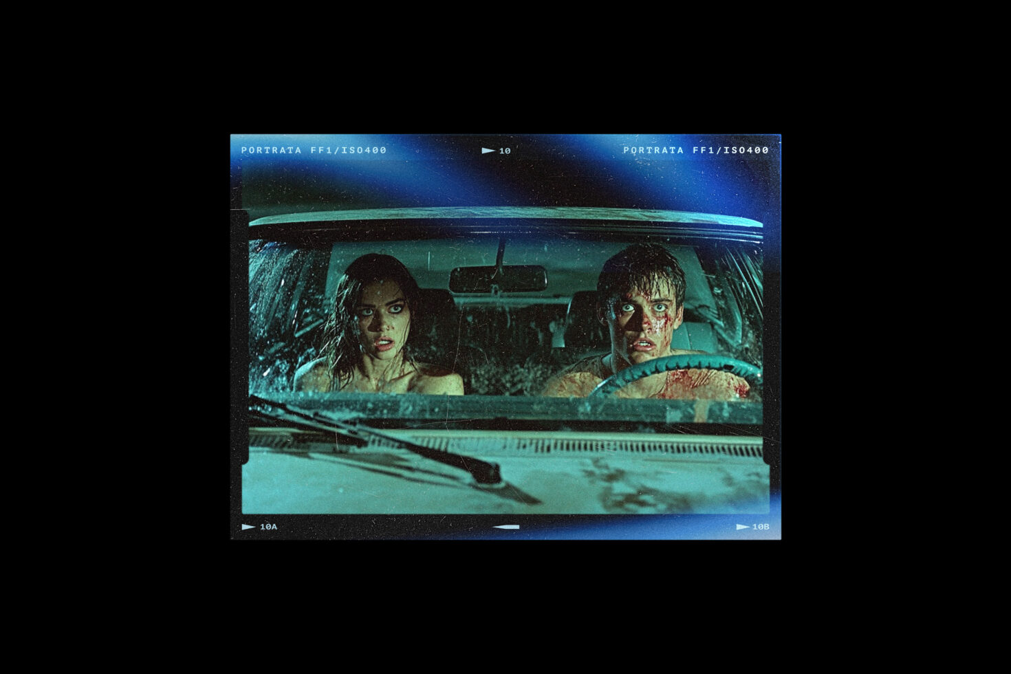 Two people inside car viewed through windshield, cool teal film stock look, cinematic frame