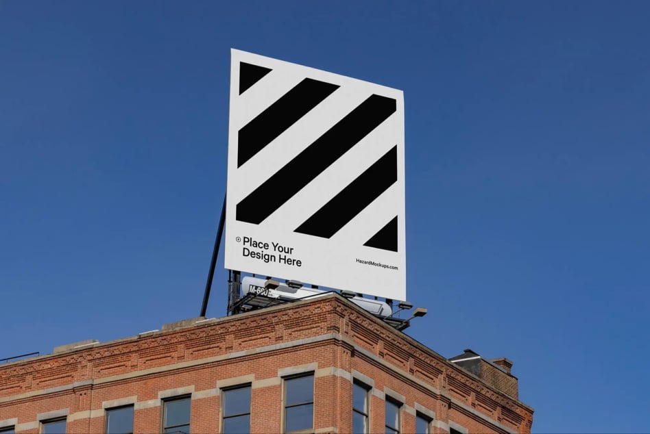 Large billboard mockup on a rooftop building under a clear blue sky. Ideal for designers showcasing outdoor advertising, graphics, urban marketing.
