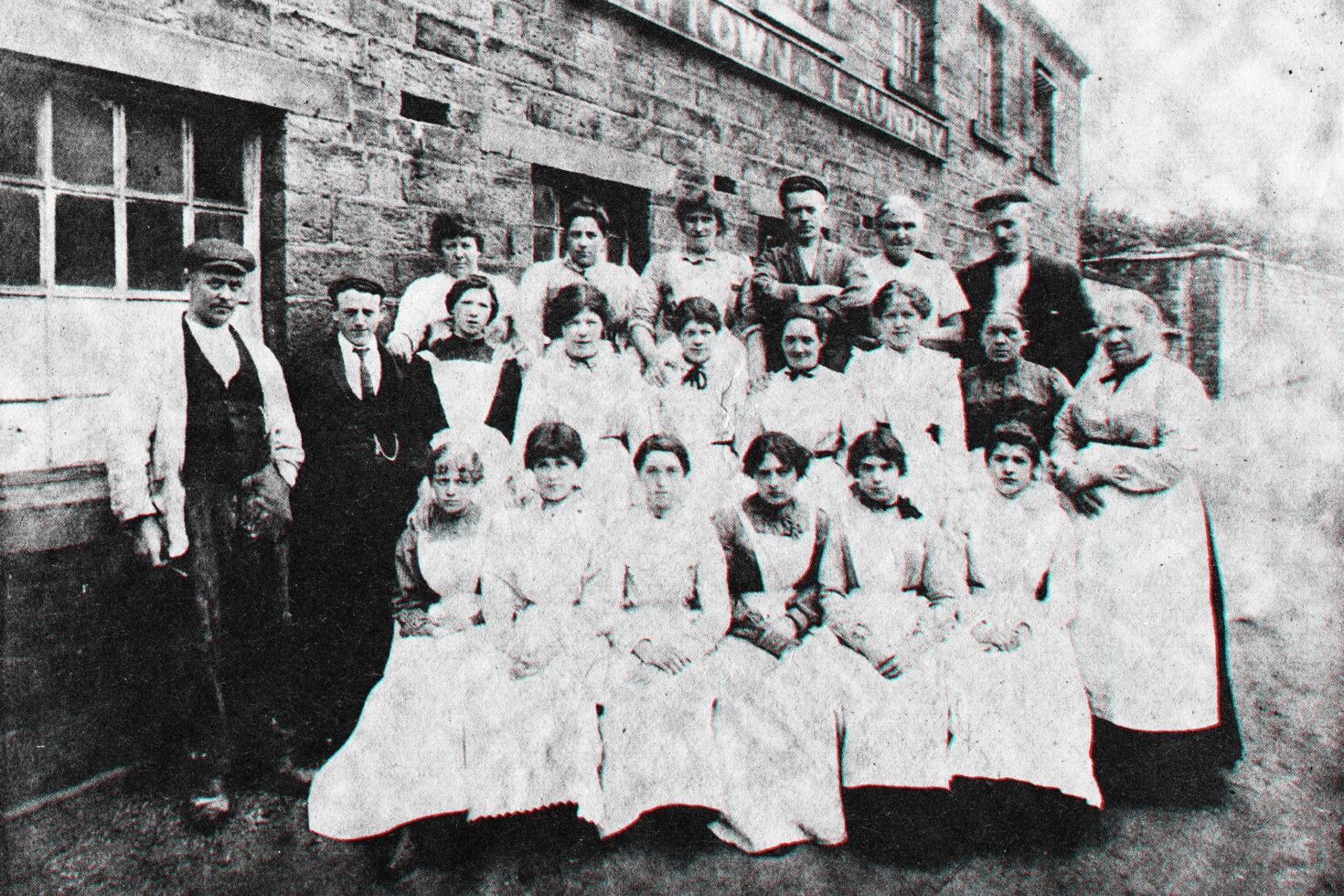 Vintage black and white photo of a group outside an industrial building suitable for historical graphics mockup use in design projects and templates.