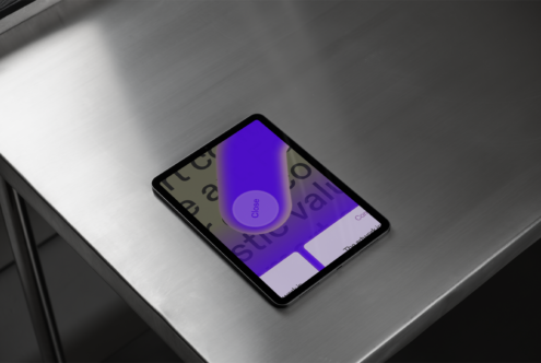 Tablet mockup on metal surface showing a close-up design interface. Ideal for digital assets, user interface design, and technology presentations.
