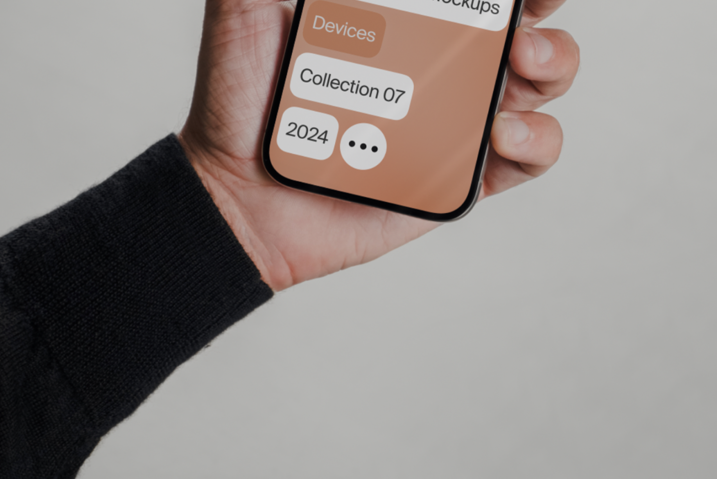 Hand holding smartphone displaying design app interface mockup. Keywords: mobile mockup, design asset, app UI, modern template, collection, 2024.