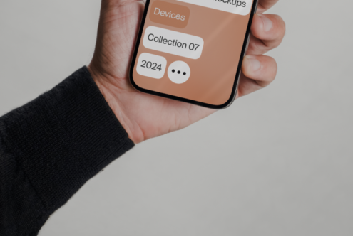 Hand holding smartphone displaying design app interface mockup. Keywords: mobile mockup, design asset, app UI, modern template, collection, 2024.