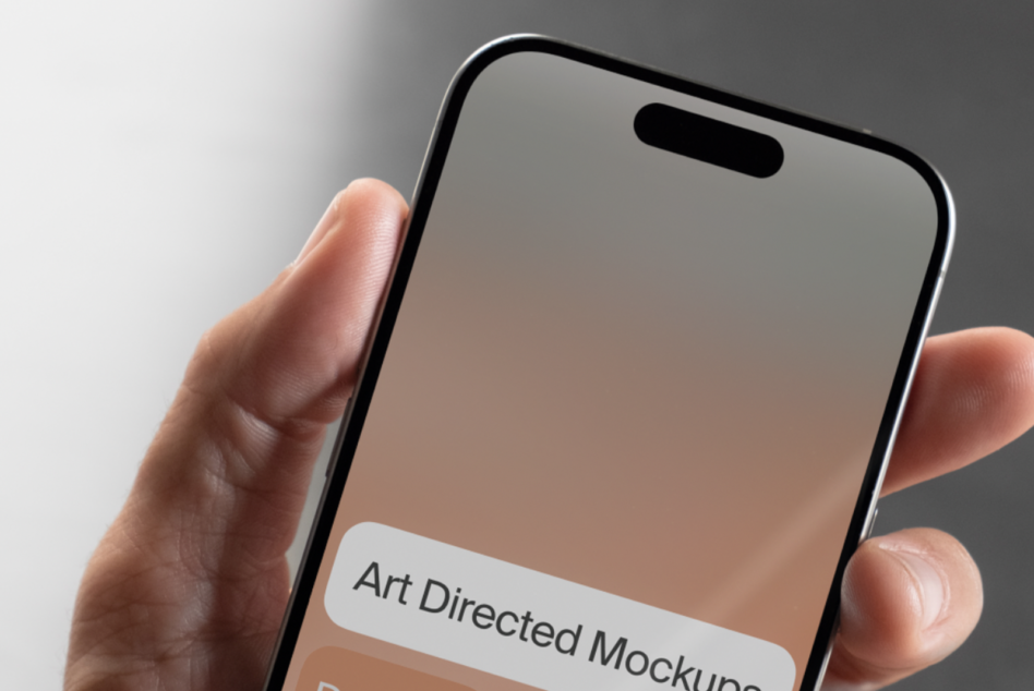 Hand holding blank iPhone mockup with soft beige gradient from top to bottom on screen