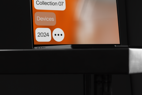 Laptop close-up showcasing a digital interface with vibrant orange graphics displaying text Collection 07 Devices 2024 Perfect for mockup designers
