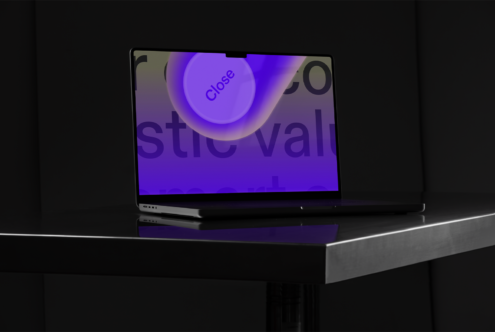 Laptop mockup on dark table displaying graphic design with purple close button. Ideal for showcasing fonts templates UI design. Suitable for designers.