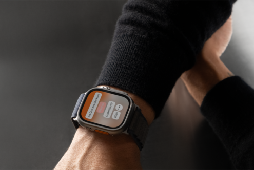 Smartwatch mockup on wrist with black strap displaying UI design with orange accents perfect for digital designers showcasing app interfaces templates.