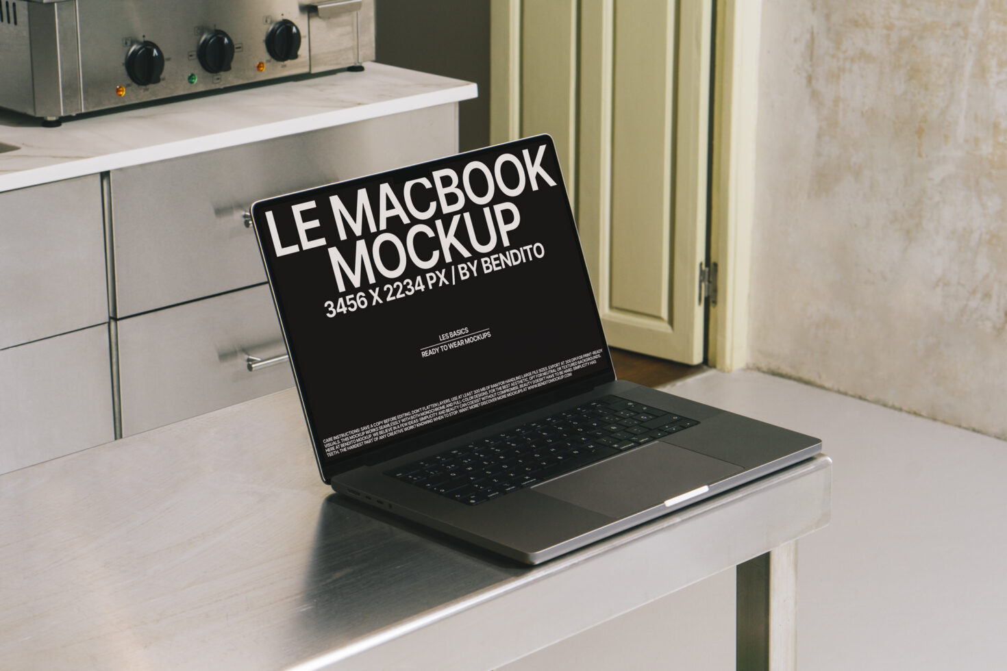 MacBook Pro mockup on kitchen counter with black screen displaying design mockup text