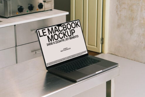 Le MacBook mockup displayed on a metal table in a kitchen setting perfect for designers seeking realistic tech presentations ideal for templates and graphics.