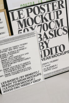 Close up of tilted poster mockup with bold serif type on white paper in wood frame