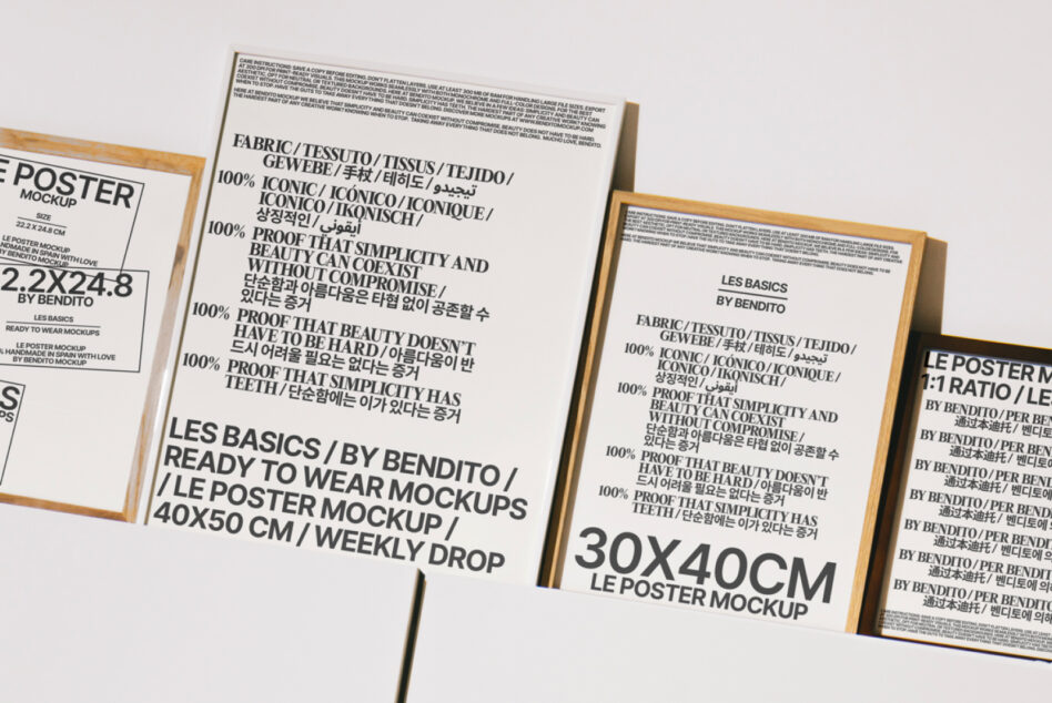 Stacked framed posters with black, white, multilingual typography in wooden frames