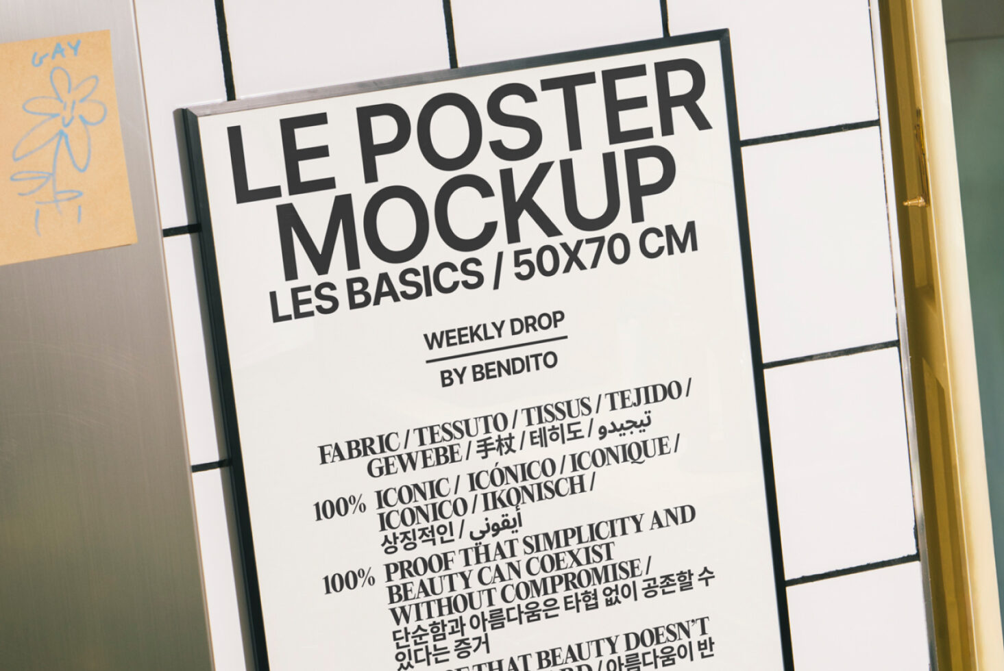 White poster mockup on grid wall with gold frame, sketched yellow card visible