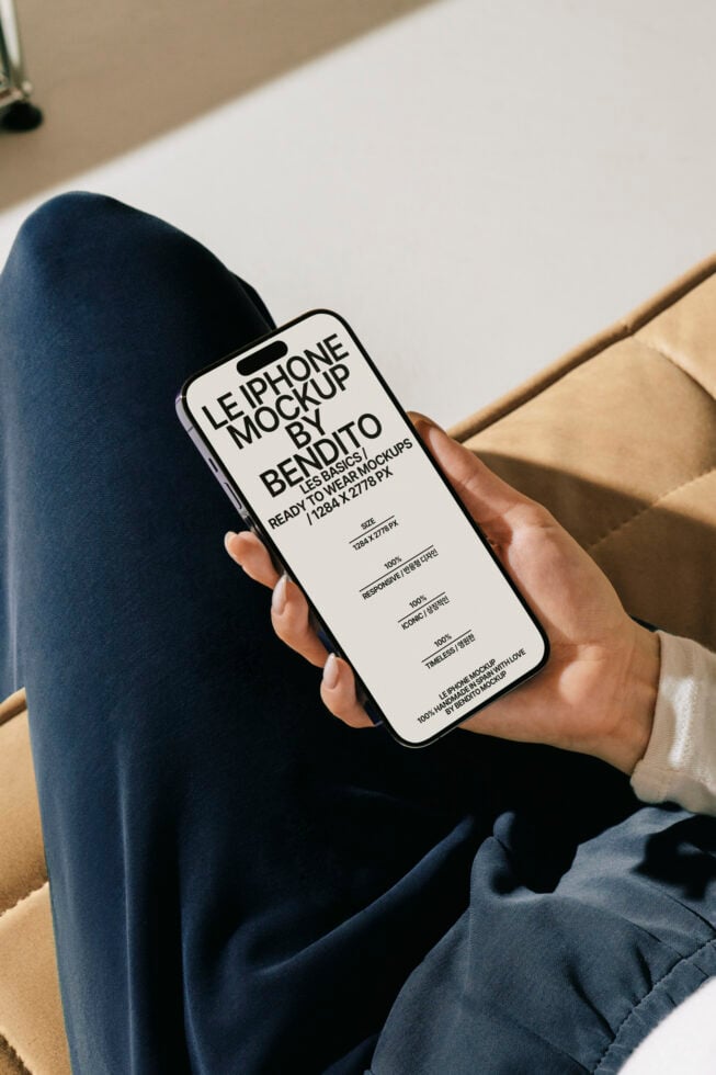 Person holding smartphone showcasing Le iPhone Mockup by Bendito; digital asset for designers; ready-to-use mockup; ideal for graphic and web design.