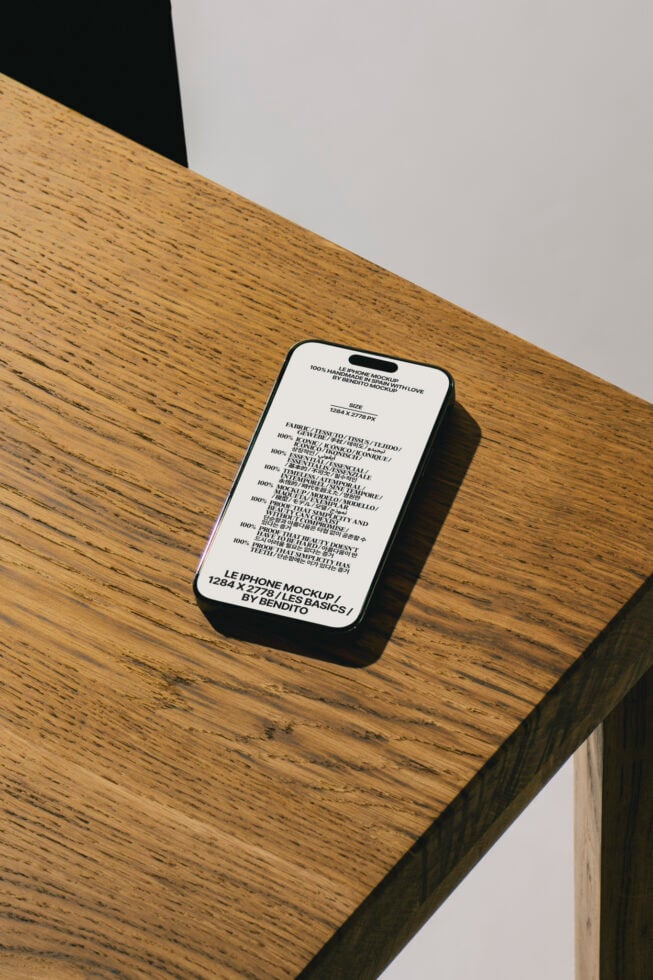 iPhone mockup on wooden table showcasing realistic design for designers. Modern smartphone PSD template perfect for UI UX presentations and branding.