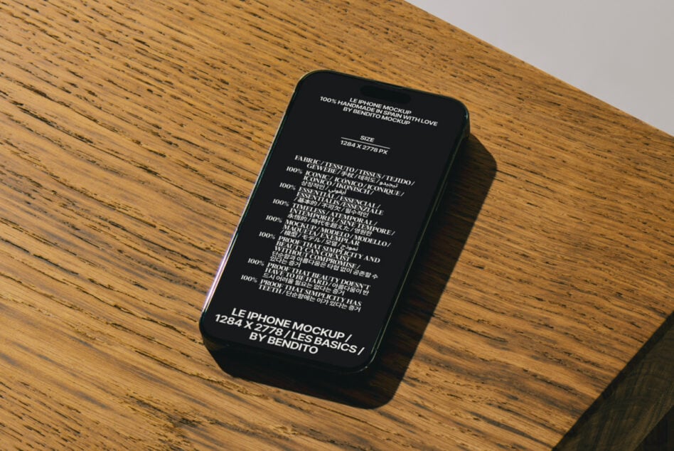 Black iPhone mockup with white text on wood surface, angled view