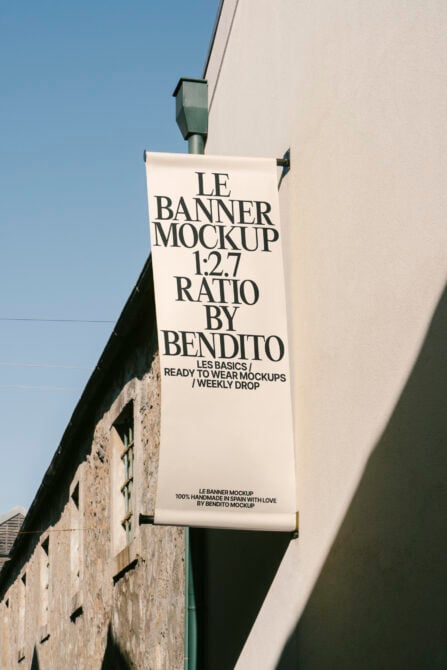Cream colored fabric banner on pole with black serif text showing 1:2.7 aspect ratio