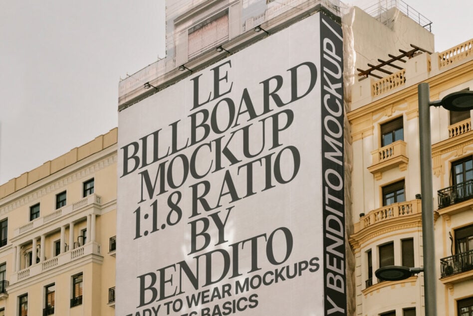 Light tall billboard corner mockup with serif typography on architecture
