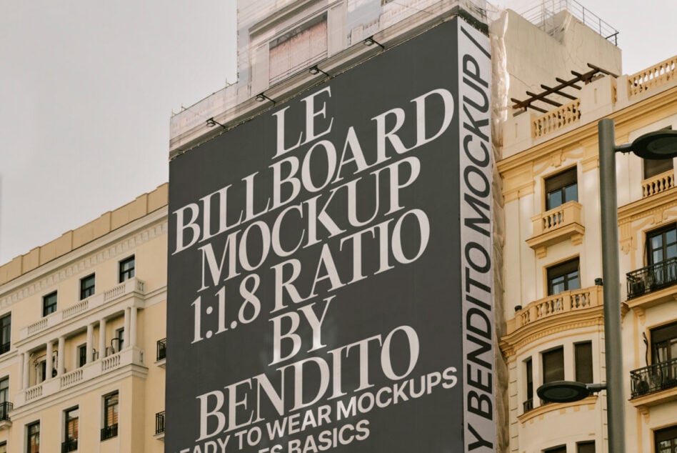 Dark tall billboard corner mockup with serif type on urban facade