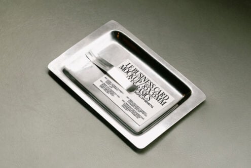 Business card mockup on a metallic tray showcasing minimal design. Ideal for designers seeking high-quality branding presentations and marketing visuals.