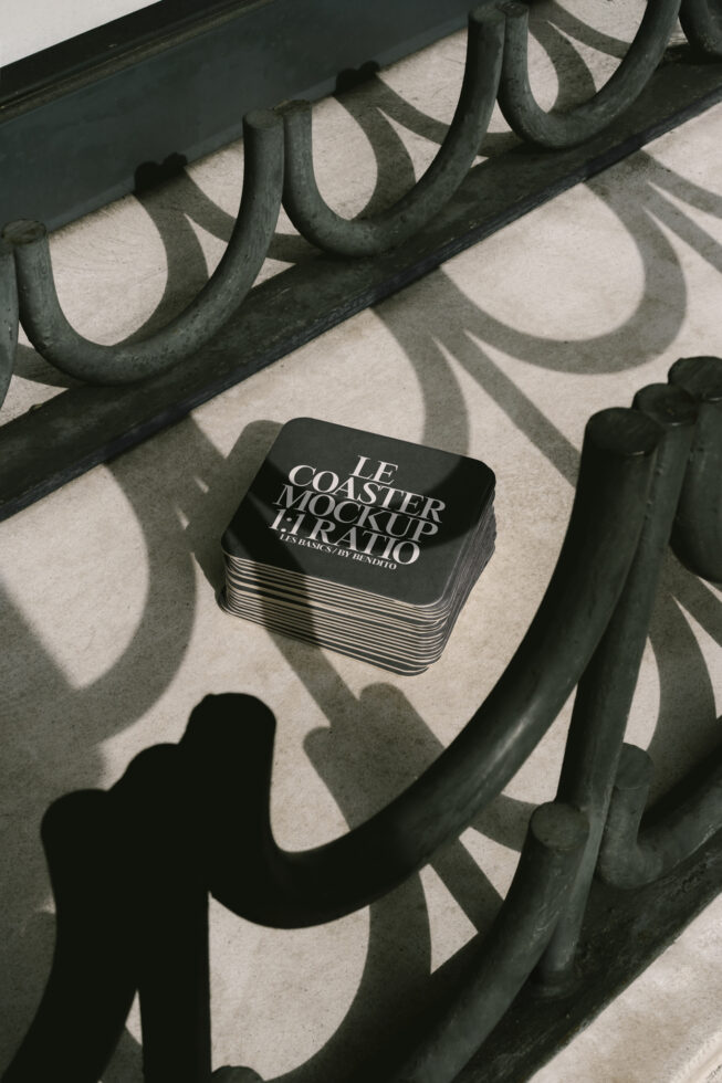 Stack of square coasters for mockup on sunlight concrete highlighting shadows. Perfect for designers seeking realistic presentation graphics.