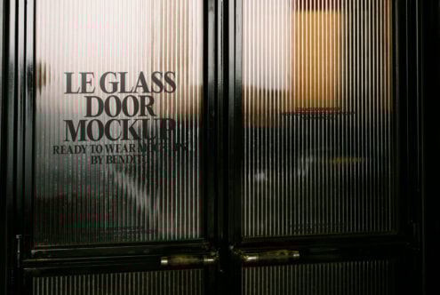 Glass door mockup with sleek handles showcasing vertical lines perfect for designers needing high-quality mockups for architectural or branding projects.
