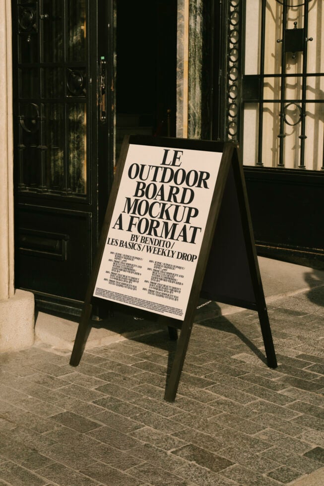 Outdoor board mockup displayed outside a storefront offering a realistic view for designers. Keywords mockup design template outdoor advertising.