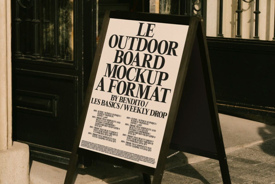 Cream A-frame sign displaying event details outside vintage black doors