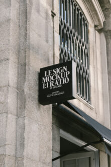 Black square corner signage mockup on concrete wall near window