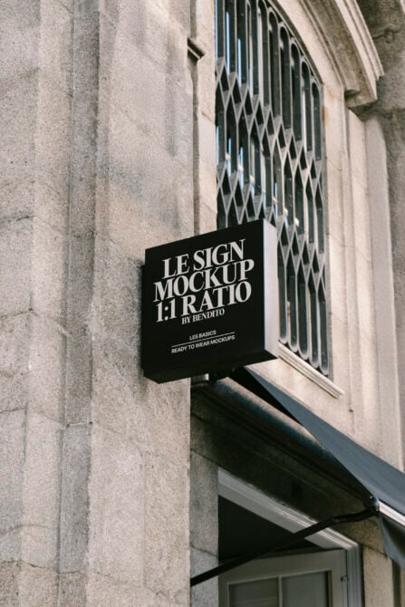 Outdoor square sign mockup on textured stone building wall perfect for branding presentations and showcasing graphic design projects realistic context