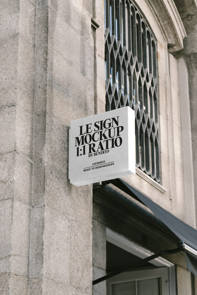 Square sign mockup on stone building exterior showcasing bold typography. Ideal for realistic advertising presentations. High-quality graphic design tool.